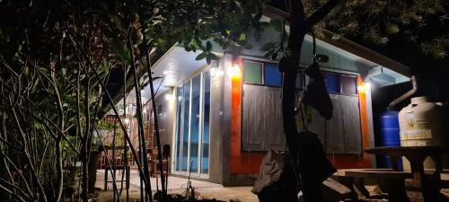 a house is lit up at night at Khaowong Resort Phang Nga - garden view 1 in Ban Thai Chang