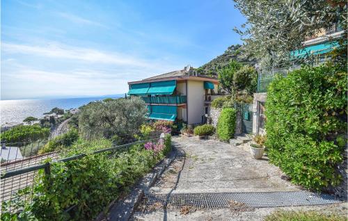 a house on a hill next to the ocean at 2 Bedroom Amazing Apartment In Recco in Recco