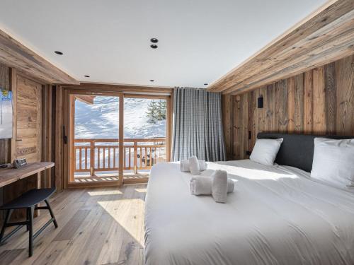 a bedroom with a large white bed and a desk at Appartement XXL familial à Courchevel, skis aux pieds, balcons, parking - FR-1-562-60 in Courchevel