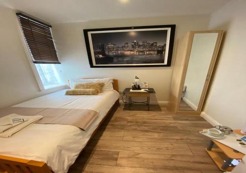 a bedroom with a bed and a table in it at Alexander Hotel in Blackpool