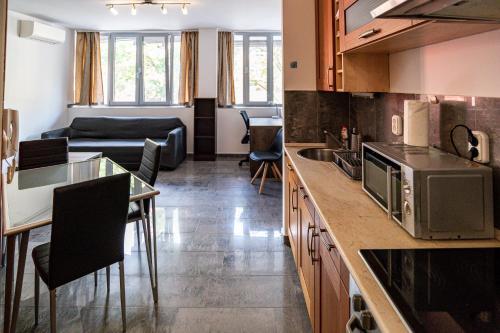 uma cozinha e uma sala de estar com um sofá em Darling Apartman em Szeged
