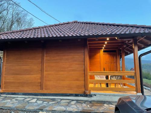 a small building with a large window on the side at Etno selo Rasinski Lug in Ravni