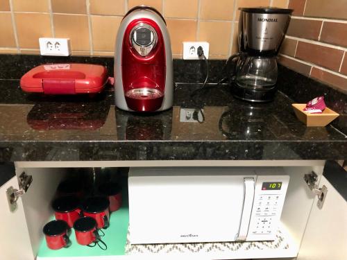 a red blender sitting on top of a counter at Gran Lençóis Flat Barreirinhas Apt 509 in Barreirinhas