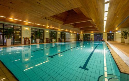 a large swimming pool in a large building at Castletroy Park Hotel in Limerick