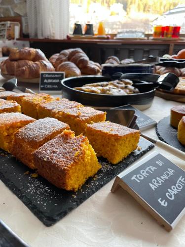 a display of breads and pastries on a table at Hotel Rech-Hof Sayonara in Folgaria