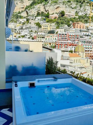 a hot tub with a view of a city at Villa Diamond Luxury Suite in Positano