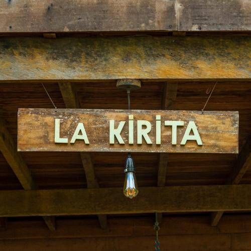 a sign that says la kiriba hanging from the ceiling at playa mecana kirita in Bahía Solano