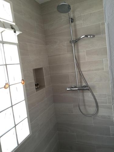 a shower with a shower head in a bathroom at Casa Acapulco in Mahón