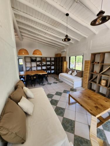a living room with a couch and a table at Saint Rose Espacio Organico en Viñedo con Piscina en Lujan de Cuyo in Mendoza