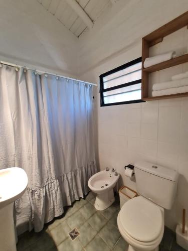 a bathroom with a toilet and a sink at Saint Rose Espacio Organico en Viñedo con Piscina en Lujan de Cuyo in Mendoza