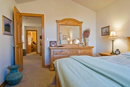 a bedroom with a bed and a dresser with a mirror at Beautiful home 10 min E of Boulder in Lafayette