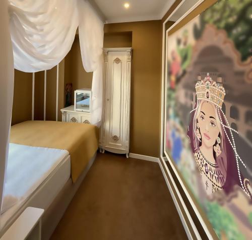 a bedroom with a painting of a princess on the wall at Seven Beauties Hotel Spa Restaurant, Old City Baku in Baku