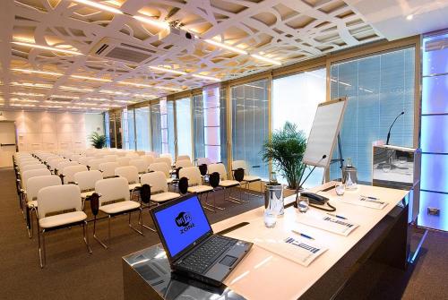 a large conference room with a laptop on a table at Hotel Imperial in San Benedetto del Tronto