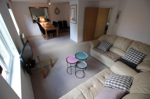 a living room with a couch and a table at 3 bedroom flat 10 mins walk to Bay and City center Free Parking in Cardiff
