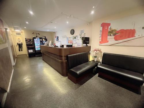 a store with two leather chairs and a cash register at Dam Hotel in Amsterdam