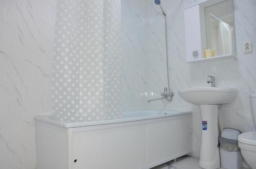 a white bathroom with a sink and a toilet at Студия №1 LifeHouseAlmaty в ЖК Теремки-2 in Almaty