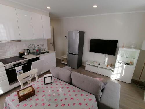a living room with a couch and a kitchen at Miragaia Star Apartments in Angra do Heroísmo