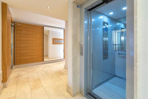 a glass elevator in a building with a hallway at MAGNOLIA - ORTI'S PLACE in Alghero