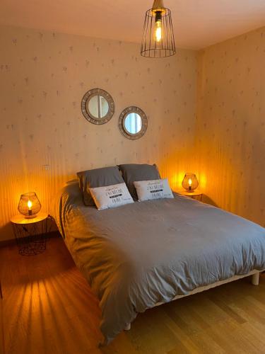 a bedroom with a bed with two pillows on it at Maison PHILIPPE et Fils in Saint-Bonnet-près-Riom