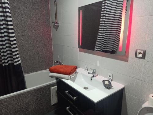 a bathroom with a sink and a red towel at Appartement la Siesta beach resort Mohammedia in Mohammedia