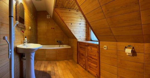 a bathroom with a sink and a bath tub at Dom Karwia in Karwia