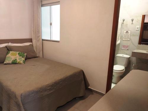 Ένα ή περισσότερα κρεβάτια σε δωμάτιο στο Pousada Show Park