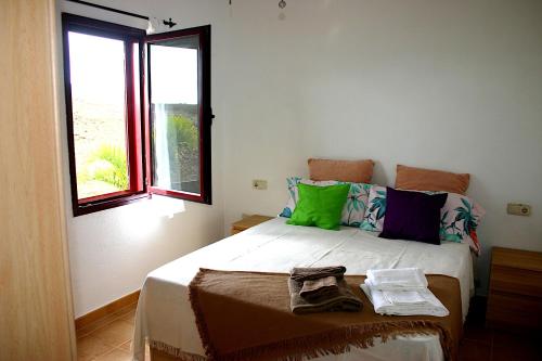 a bedroom with a bed and a window at Casa Livia Pool & Sunset in Corralejo