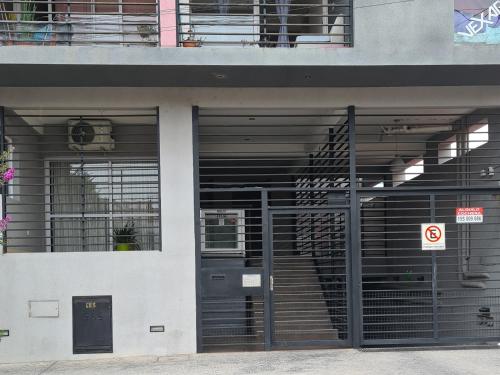 a building with doors and windows with a no parking sign at Altos del Rey Apartamentos in San Salvador de Jujuy