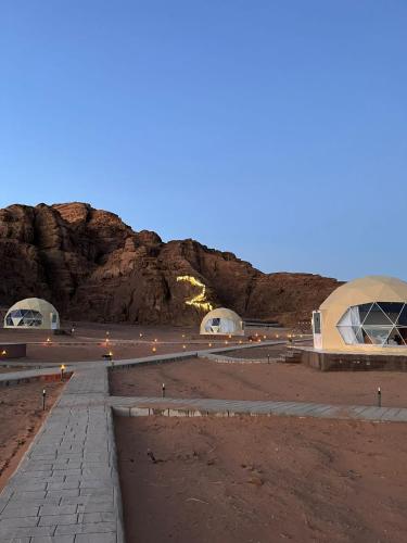 a view of a desert with a mountain in the background at Nara Wadi RUM Camp in Wadi Rum