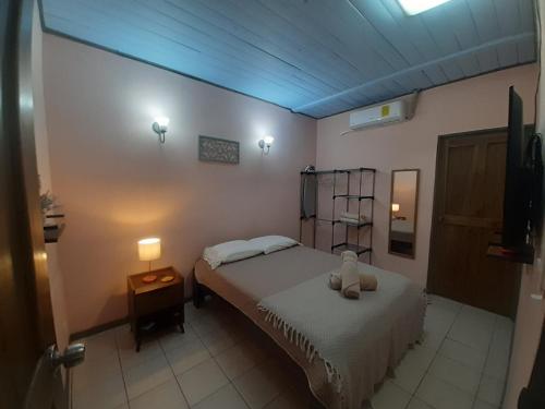 a small bedroom with a bed and a night stand at La Estancia Ideal Apartamentos in Fortuna