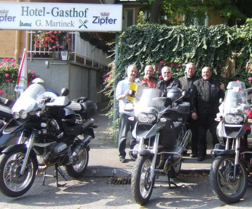 a group of people standing next to parked motorcycles at Hotel-Garni Martinek in Baden