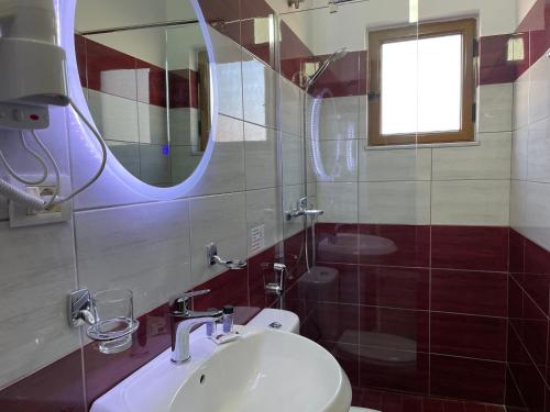 a bathroom with a sink and a mirror at Summer Dreams in Ksamil