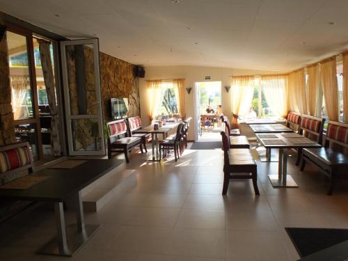 a dining room with wooden tables and chairs at Hotel Green Smiltynė in Panevėžys