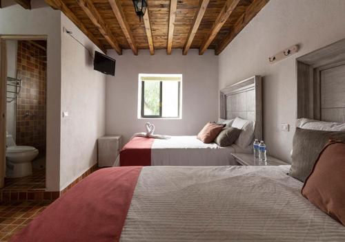 Cama o camas de una habitación en Hotel & Temazcal Hacienda Maxthá