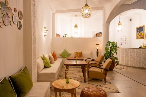 a living room with a couch and a table at Riad Dar Blanche & Spa in Marrakech