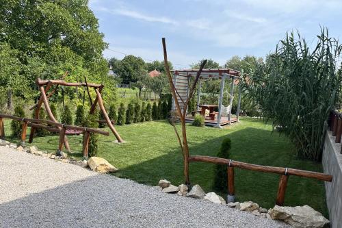 a garden with a playground and a swing at Ubytovanie AGATE in Podhájska