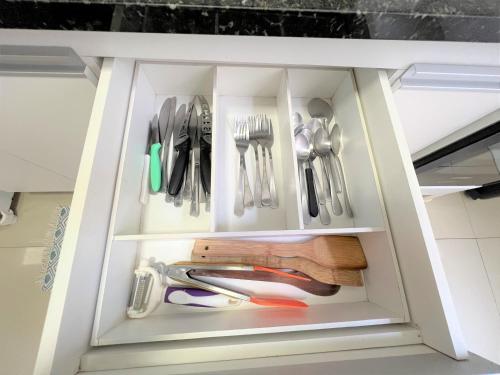 a drawer filled with utensils in a kitchen at Apê Tijucano Arejado e Silencioso - 5 min do metrô in Rio de Janeiro