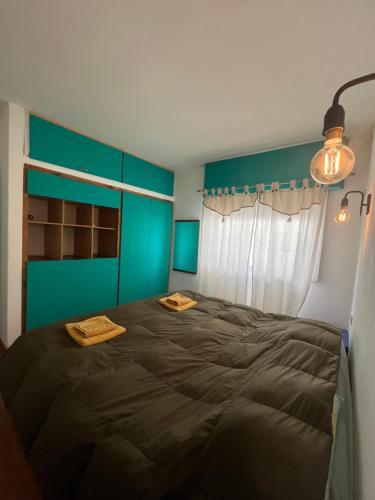 1 dormitorio con 1 cama grande y pared azul en - Refugio de MAR - en Playa Unión