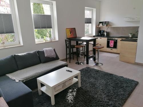 a living room with a couch and a table at Chill-out in Heilbad Heiligenstadt