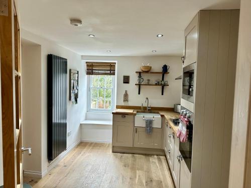 a kitchen with a sink and a counter top at Brechin Townhouse - Cathedral View in Brechin