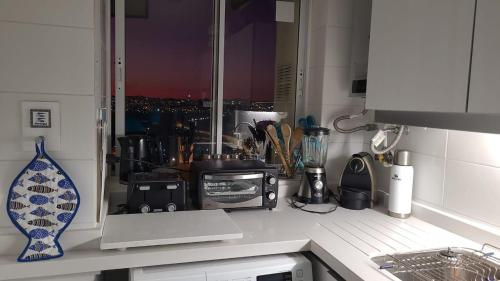 a kitchen with a counter top with a view of a city at Bella Vista in Coquimbo