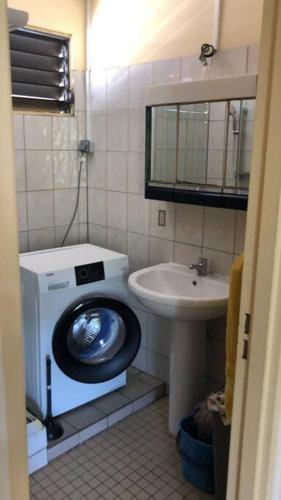 a bathroom with a toilet and a sink at Maison Bourg des Anses d'Arlet in Les Anses-dʼArlets