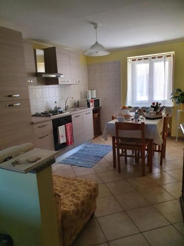 a kitchen and dining room with a table and a dining room at B&B del Borgo in Mondovì
