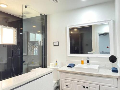 a white bathroom with a sink and a shower at 3Bedroom 2Bath 15 Min to strip 10 downtown in Las Vegas