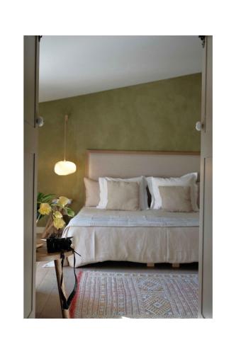 a bedroom with a bed with a large mirror at Les Jardins de Sitaara in Cucuron