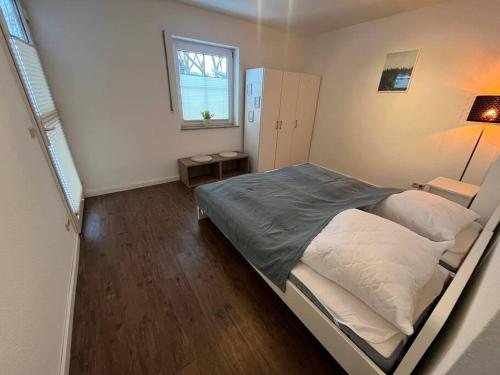 a bedroom with a large bed and a window at Ferienhaus im Thüringer Wald in Struth-Helmershof