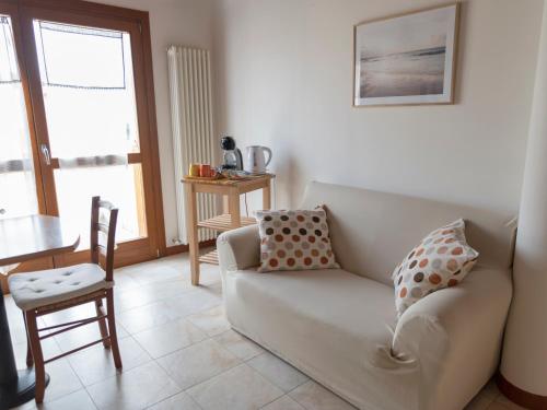 a living room with a couch and a chair at Appartamento ISOTTA in Lugo