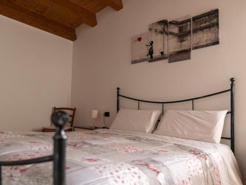 a bedroom with a large bed with white pillows at Appartamento ISOTTA in Lugo