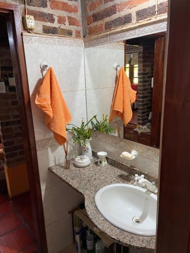 a bathroom with a sink and a mirror at Casa con piscina y parque in Garupá
