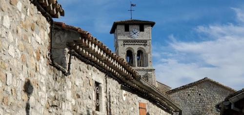 a clock tower on top of a building at Maison du Baron - Centre historique de RUOMS in Ruoms
